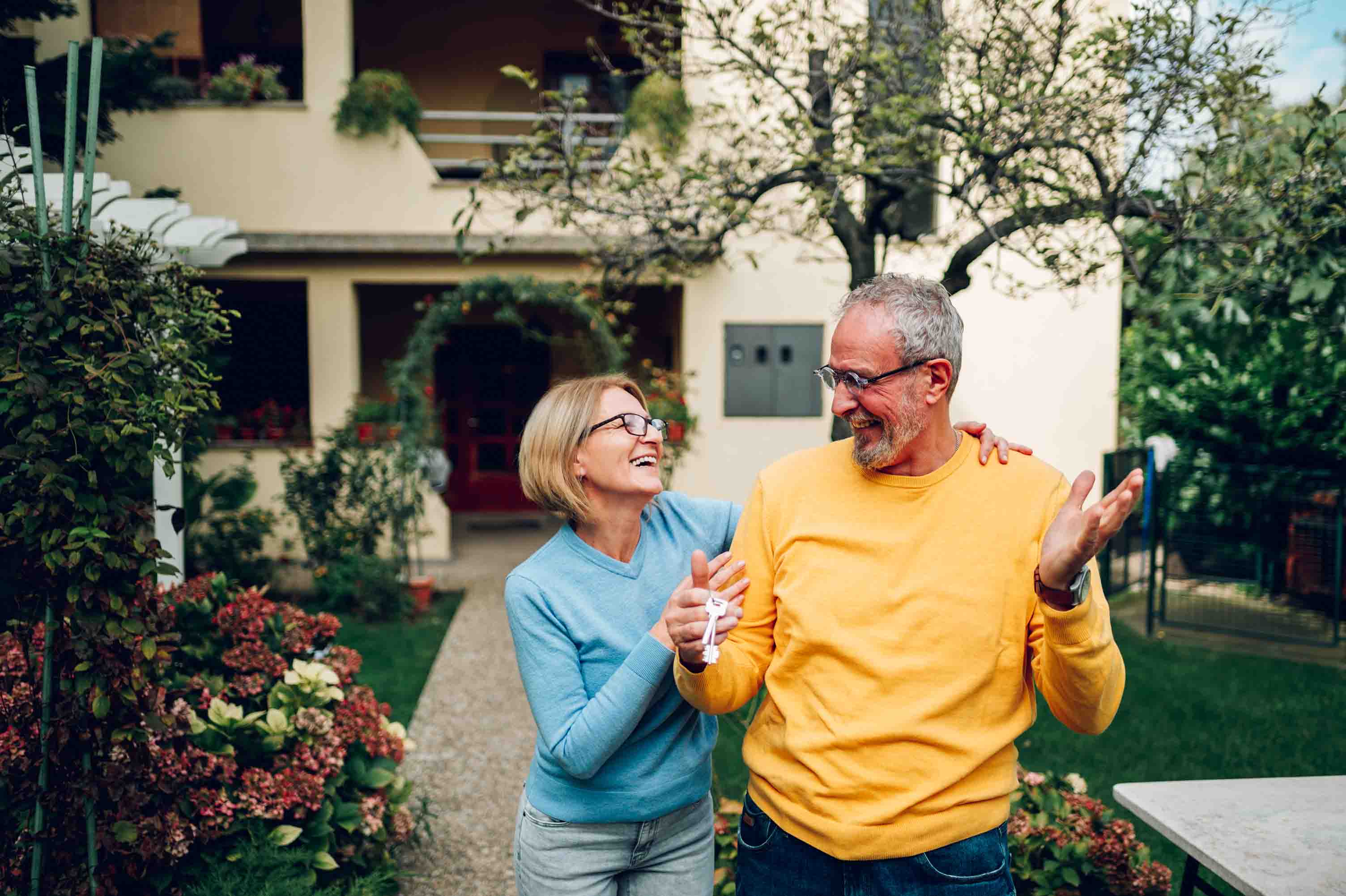 A couple celebrating outside their home